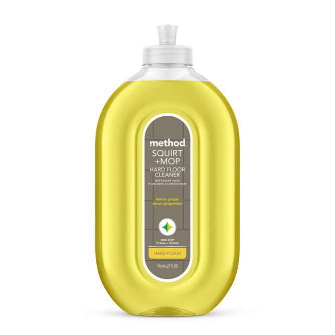 A clear bottle of method Squirt & Mop Hard Floor Cleaner with lemon ginger scent, containing yellow liquid and a gray label with green and white text. The flip-top cap cleaner is Leaping Bunny–certified and ideal for no-wax floors.