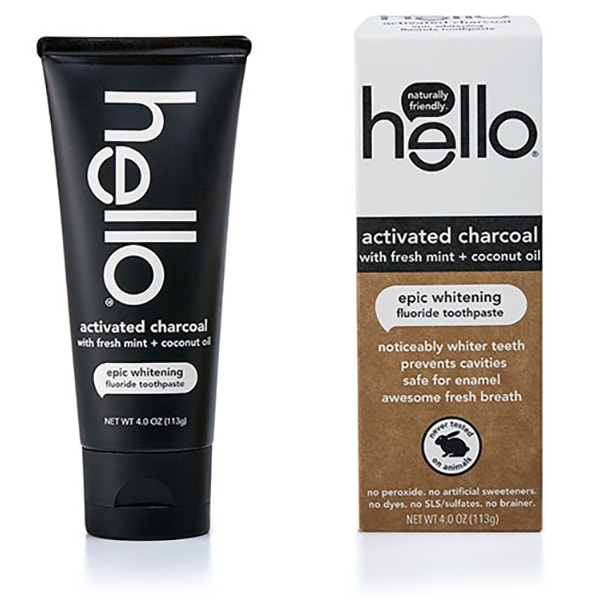 The hello Activated Charcoal Whitening Fluoride Toothpaste claims epic whitening with fresh mint and coconut oil, emphasizing cavity prevention without artificial sweeteners. Its sleek black tube contrasts with the white and brown packaging for a natural touch.