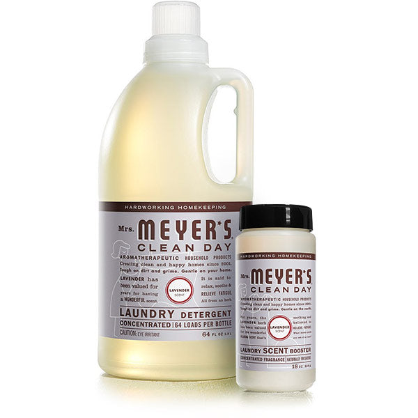 Mrs. Meyers Laundry Detergent & Scent Booster Set includes a large bottle of lavender-scented detergent and a smaller scent booster, both with white labels and lavender accents, offering freshness and charm in every wash.