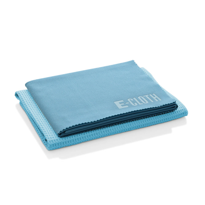 A folded blue cloth labeled E-CLOTH rests on a white background. Its texture ensures streak-free cleaning, making the E-Cloth Window Cleaning Kit essential for spotless windows.
