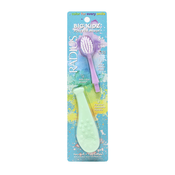 The RADIUS Big Kidz® Forever Brush™ is a packaged purple toothbrush with a light green textured handle and slim neck. The colorful packaging indicates its BPA-free, bio-based bristles, made in the USA, and suitable for ages 6+.