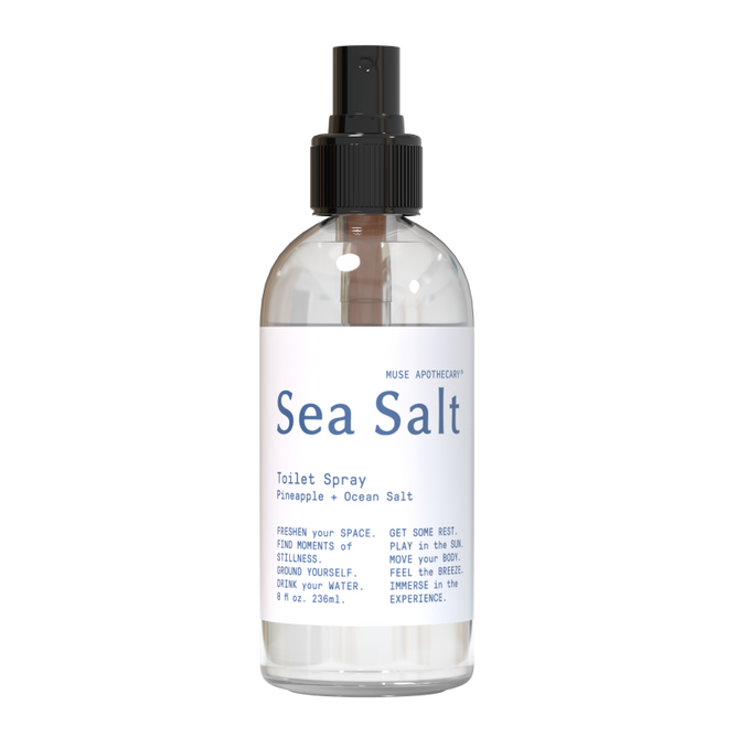Muse Apothecarys Toilet Spray, in an 8 oz clear bottle with a black nozzle, offers a Pineapple + Ocean Salt scent. Its plant-based formula enhances your bathroom with a refreshing aroma for revitalizing moments.