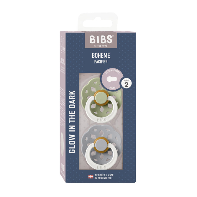 The BIBS Natural Latex Rubber Glow in the Dark Pacifier, Size 2 (6-18 Months), includes two pacifiers in muted green and beige. Made from natural rubber, they feature glow-in-the-dark designs and Danish-made quality to support breastfeeding effectively.