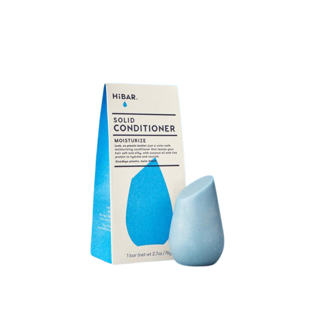 The HiBAR Moisturize Conditioner is a blue, raindrop-shaped solid conditioner for dry frizzy hair. It comes in cream and blue packaging that highlights its nourishing ingredients and product name.