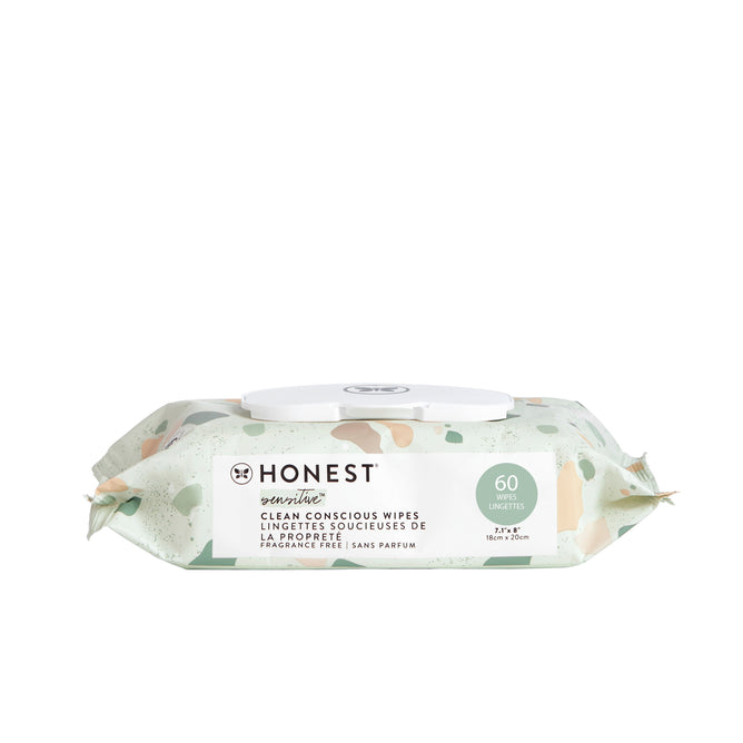 A pack of Clean Conscious™ Wipes by The Honest Company. The pale green packaging features abstract peach and cream shapes, containing 60 fragrance-free, hypoallergenic wipes for sensitive skin with a convenient white plastic dispenser lid.