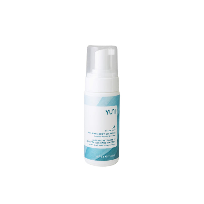 A white and blue bottle of YUNIs Flash Bath No-Rinse Body Cleansing Foam with a pump dispenser sits against a plain white background. This 4 fl oz (118 ml) product is moisturizing, all-natural, vegan, and ideal for waterless body cleansing.