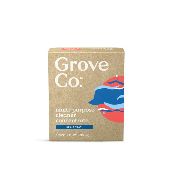 A brown box labeled Grove Co. contains two 1 fl oz (50 ml) packs of Multi-Purpose Cleaner Concentrate with a sea spray scent, featuring a blue and red wave design. Crafted from bio-based ingredients in recyclable glass packaging, it enhances eco-friendly appeal.