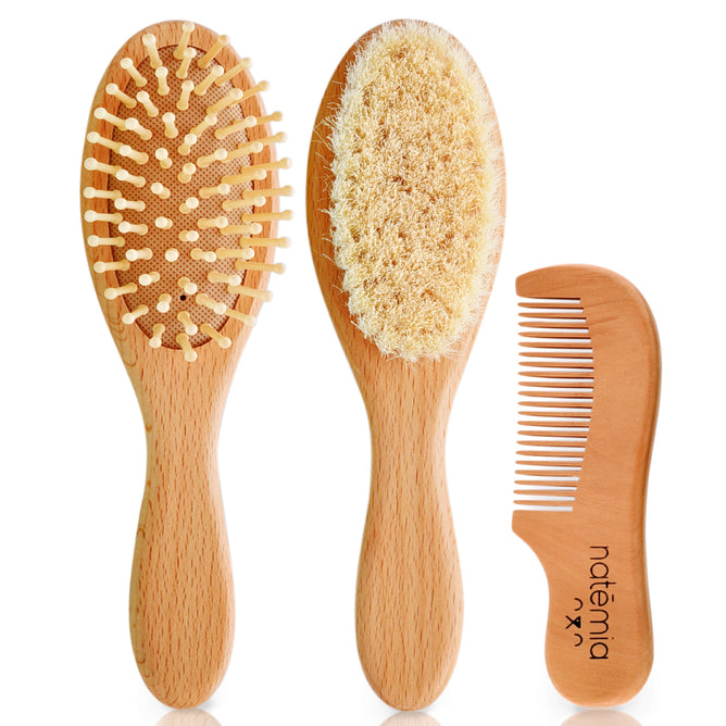 The Wooden Baby Hair Brush & Comb Set by Natemia includes three accessories: a soft scalp brush, a cradle cap brush with wooden bristles, and a small comb with the Natemia logo. Each item has light wood handles, ideal for gentle care.