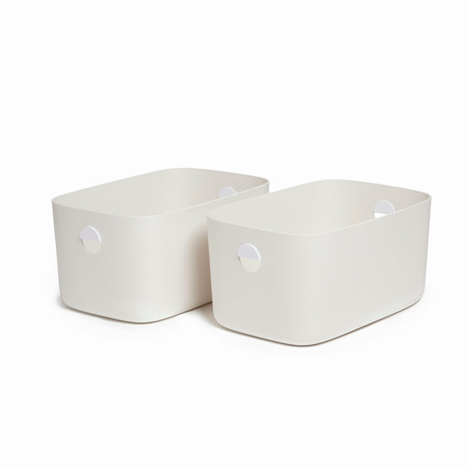 Two Large Storage Bins by Open Spaces, known for their durability, feature rounded edges and circular handles. They sit side by side against a white background, displaying their stackable design perfect for efficient storage.