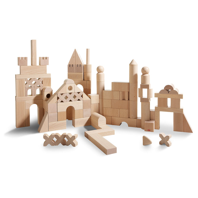The HABA Basic Building Blocks - Extra Large Wooden Starter Set offers sustainably sourced building blocks in natural wood tones, including rectangles and cylinders, perfect for constructing creative towers and arches with inventive stacking possibilities.