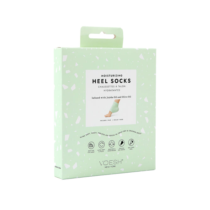 A mint green box of VOESH New York Moisturizing Heel Socks is set against a plain white backdrop, emphasizing its luxurious infusion with jojoba and olive oils.