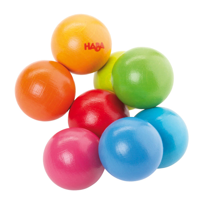 The HABA Magica Wooden Clutching Toy, featuring interconnected spheres in yellow, orange, red, green, light green, pink, and two blues, is a colorful and sustainable non-toxic baby toy marked with HABA on one yellow sphere.