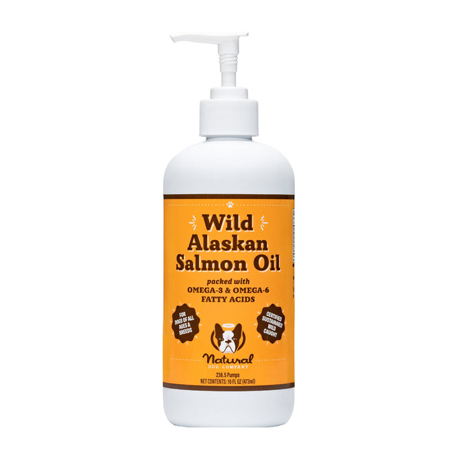 The 32 fl oz white pump-dispenser bottle, Wild Alaskan Salmon Oil by Natural Dog Company, features an orange label promoting Omega-3 & Omega-6 Fatty Acids. It includes a dog illustration and supports canine immune health naturally.
