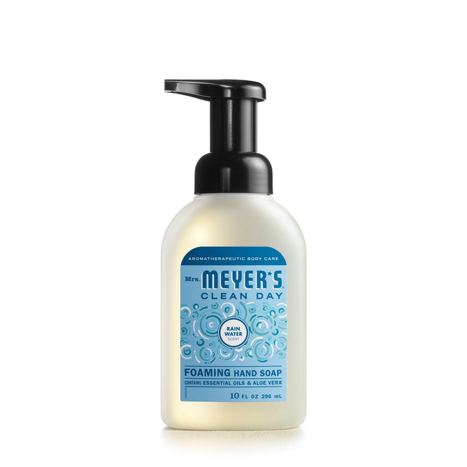 Mrs. Meyers Foaming Hand Soap, enriched with essential oils, comes in a 10 fl oz pump bottle featuring a refreshing Rain Water scent. The label is light blue with white and dark blue text and decorated with bubbles.