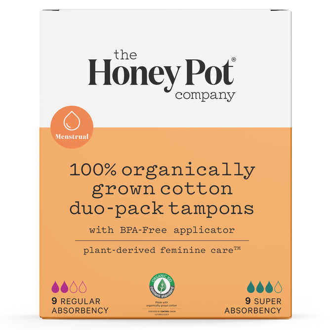 The image displays The Honeypot Companys Duo Pack Tampons, made from 100% natural organic cotton and featuring BPA-free applicators. The vibrant orange and white pack offers complete coverage with 9 regular and 9 super absorbency options, adorned with a menstrual symbol.