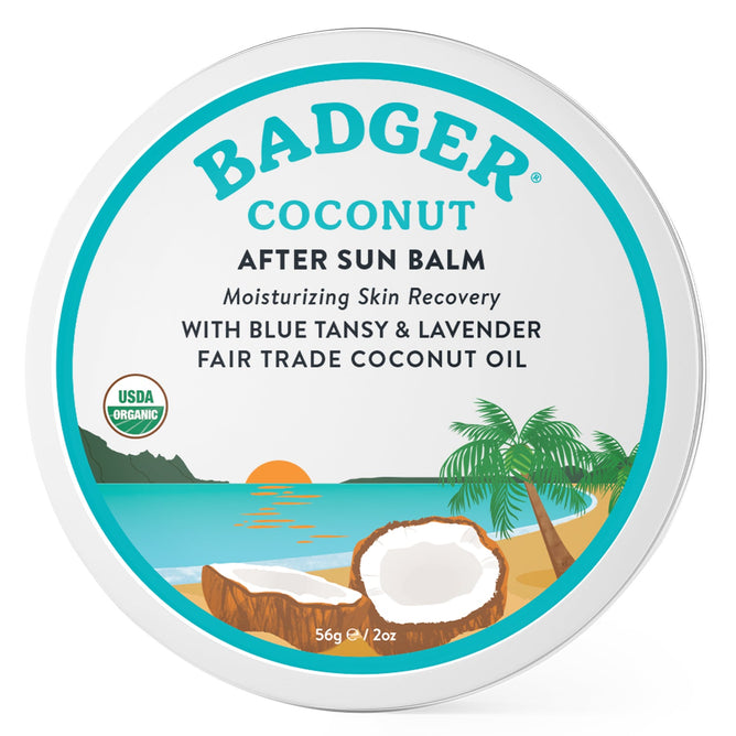 The Coconut After Sun Balm Tin by Badger Balm features a beach scene with a palm tree, ocean, and sunset. It highlights moisturizing skin recovery with blue tansy, lavender, and coconut oil. The USDA Organic logo is included for reassurance.