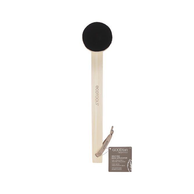The EcoTools Self-Tan Back Applicator has a light wooden handle with Ecotools inscribed, and a black rounded sponge for a natural tan. A small tag includes product details.