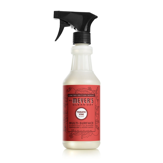 A Mrs. Meyers Tomato Vine Multi-Surface Cleaner bottle featuring a red label with floral designs and a black spray nozzle.