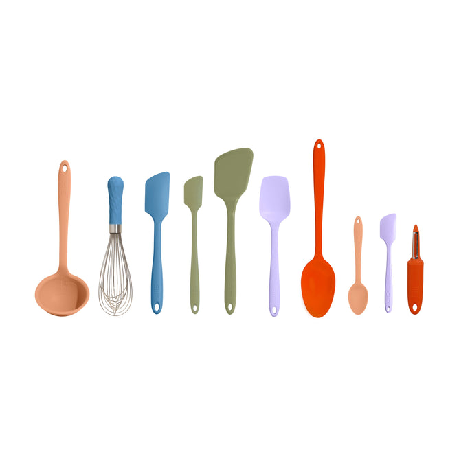 The 10-Piece Best Sellers Kitchen Tool Set by GIR features nine silicone tools like a ladle, whisk, and colorful spatulas in peach, blue, green, lavender, and orange with hanging holes. Made from heat-resistant platinum-cured silicone for durability. A small peeler complements the lineup on the right.