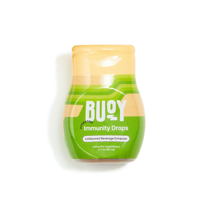 A 2 fl oz (60 ml) bottle of Buoy Hydrations Immunity Drops offers unsweetened electrolyte and immune support for any beverage. The green-and-orange packaging emphasizes its role as an immunity booster.