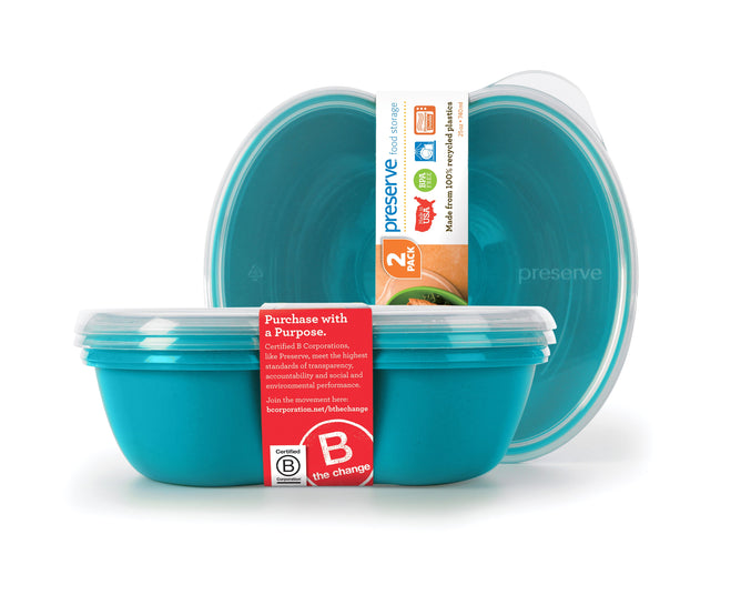 Two turquoise Preserve Food Storage Sandwich containers feature clear lids. One is open with a band displaying the Preserve logo, emphasizing its use of recycled plastic and commitment to environmental responsibility.