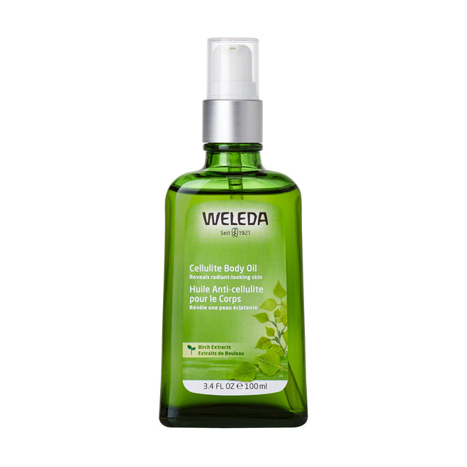 A 3.4 fl oz (100 ml) Weleda Birch Cellulite Body Oil in a green glass bottle with a white pump. The label, with English and French text, highlights Rich Extracts and birch leaf illustrations. Contains jojoba oil for effective cellulite reduction.
