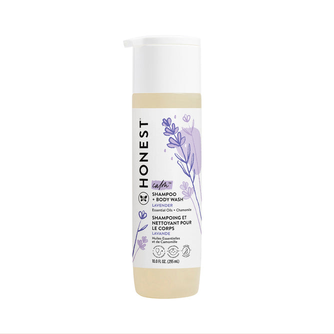 10 fl oz (295 ml) bottle of The Honest Company lavender-scented Shampoo + Body Wash, featuring a tear-free formula with Aloe + Chamomile Extracts. The white label with purple lavender illustrations and a cream-colored cap details the product information.