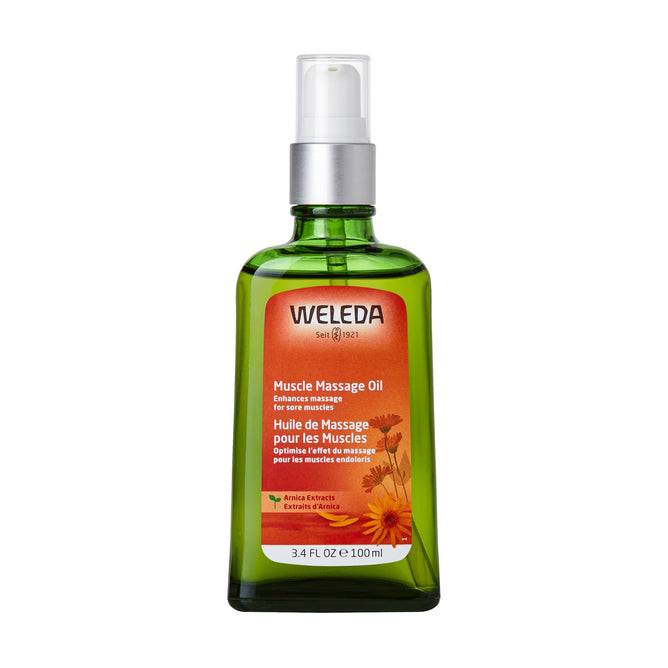 The Weleda Arnica Muscle Massage Oil comes in a 3.4 FL OZ / 100 ml green glass bottle with a white pump dispenser, featuring a label with yellow flowers and bilingual text highlighting arnica extracts and essential oils, ideal for enriching massages.