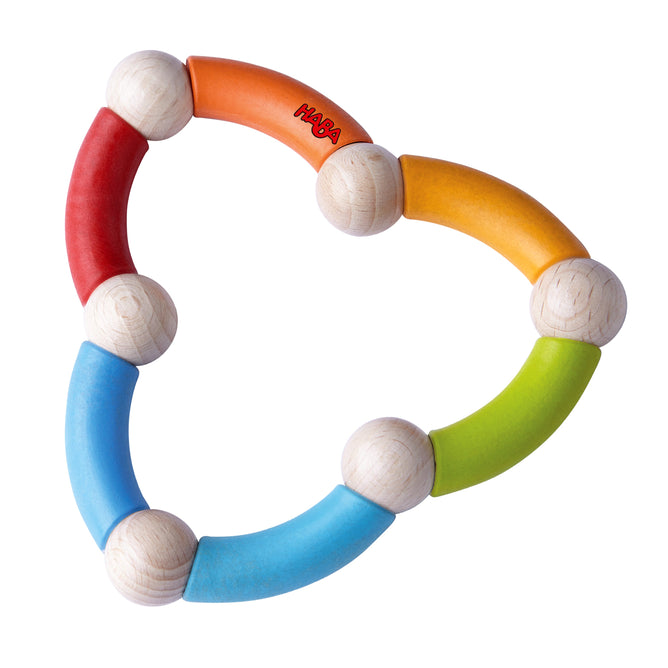The Color Snake Wooden Rattle & Fidget Toy by HABA is a vibrant circular baby toy made of interconnected wooden beads and curved segments in red, orange, yellow, green, and blue. Its eco-friendly design enhances gross motor skills and features the HABA brand on an orange segment.