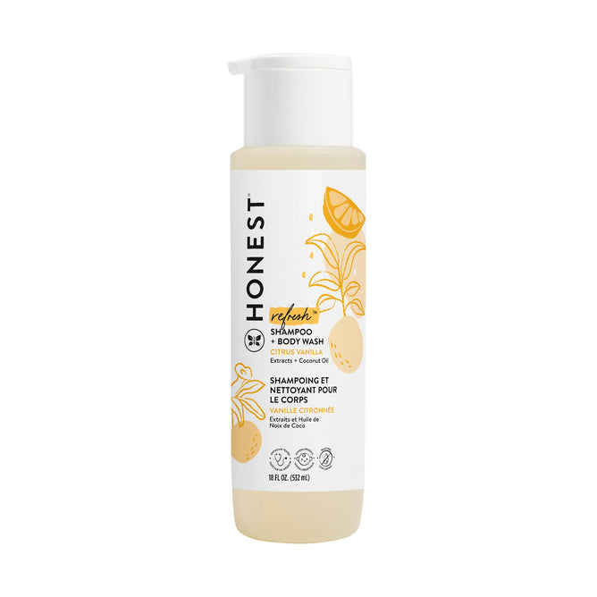 A 10 fl oz (296 ml) bottle of The Honest Company Shampoo + Body Wash features citrus graphics and a Vanilla + Lemon label, incorporating coconut, lemon, calendula, and chamomile extracts for revitalizing cleansing.