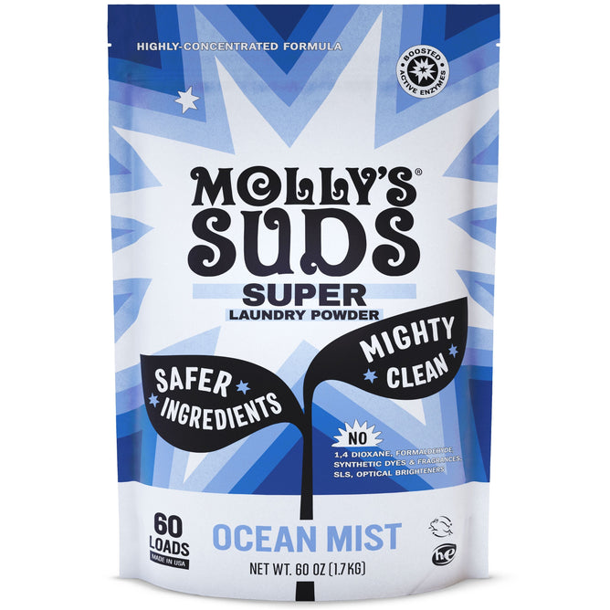 A blue and white package of Mollys Suds Super Powder labeled Ocean Mist highlights natural ingredients for sensitive skin, ensuring safer components and a powerful clean without harmful chemicals. It offers 60 ounces for 60 loads, with a starburst design and icons.