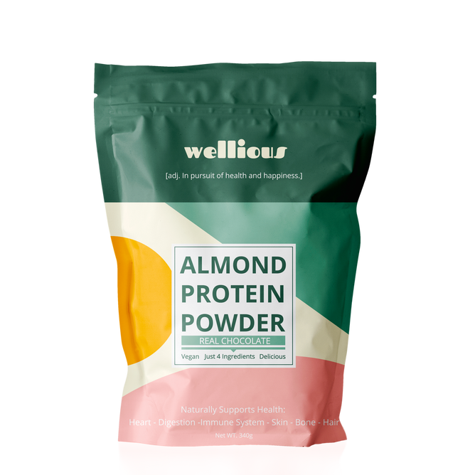 A green, orange, and cream-colored pouch of Wellious Almond Protein Powder in real chocolate flavor is 100% vegan with only four ingredients, promoting heart health, digestion, immune system support, and benefits for skin, bones, and hair.