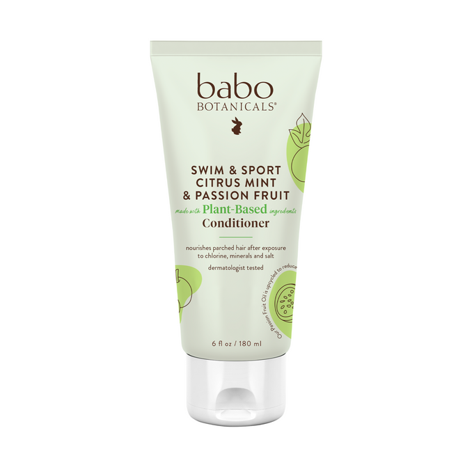 A 6-ounce tube of Babo Botanicals Swim & Sport Conditioner comes in light green packaging with citrus and passion fruit designs, highlighting its plant-based formula and dermatological testing, featuring sustainably sourced passion fruit oil.