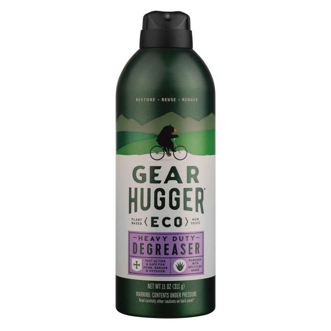 A green-and-black can of Gear Hugger Heavy Duty Degreaser features a cyclist silhouette against mountains, highlighting its non-toxic, plant-powered formula that supports restore, reuse, reduce principles.