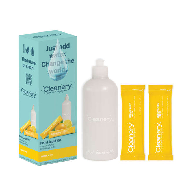 The Cleanery Dish Liquid Starter Kit is an eco-friendly product in a blue and yellow box. It includes a white reusable bottle and two lemon fresh refill sachets, promoting the message: Just add water. Change the world.