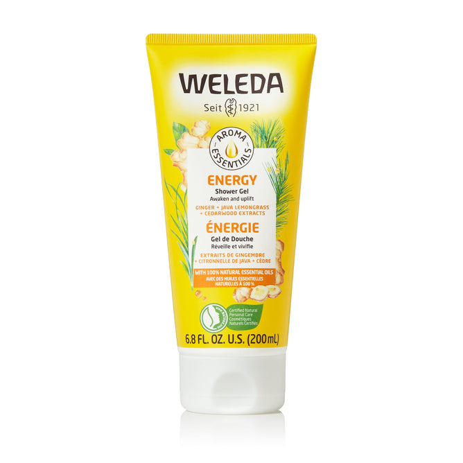 A 6.8 fl oz (200 ml) yellow tube of Weleda Energy Shower Gel features botanical illustrations and text in English and French, infused with ginger, java lemongrass, and cedarwood extracts.