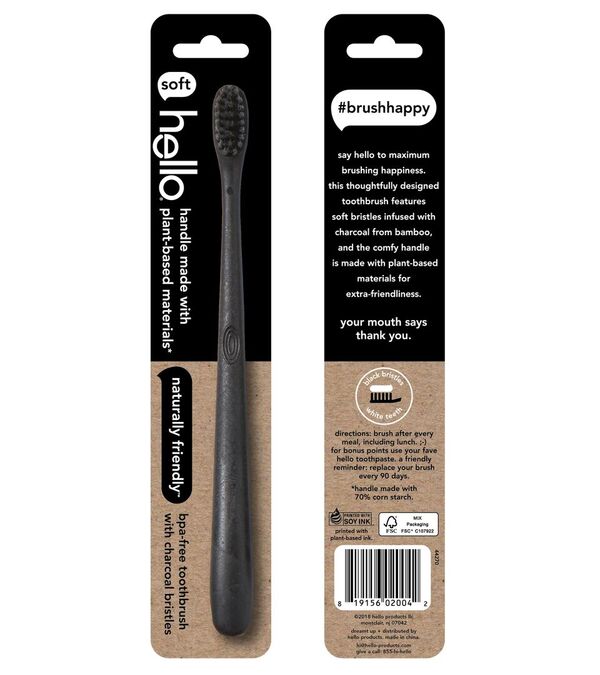 The packaging displays a sleek black hello toothbrush with an eco-friendly plant-based handle and activated charcoal bristles. The front highlights the product name Charcoal Bristle BPA-Free Toothbrush, while the right emphasizes its sustainable materials and the #brushhappy label.
