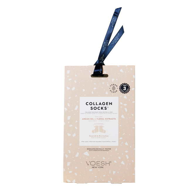 The Collagen Socks Trio by VOESH New York comes in cream packaging with a speckled pattern and a dark blue ribbon, featuring a vegan formula enriched with argan oil and floral extracts for nourishing and revitalizing benefits.