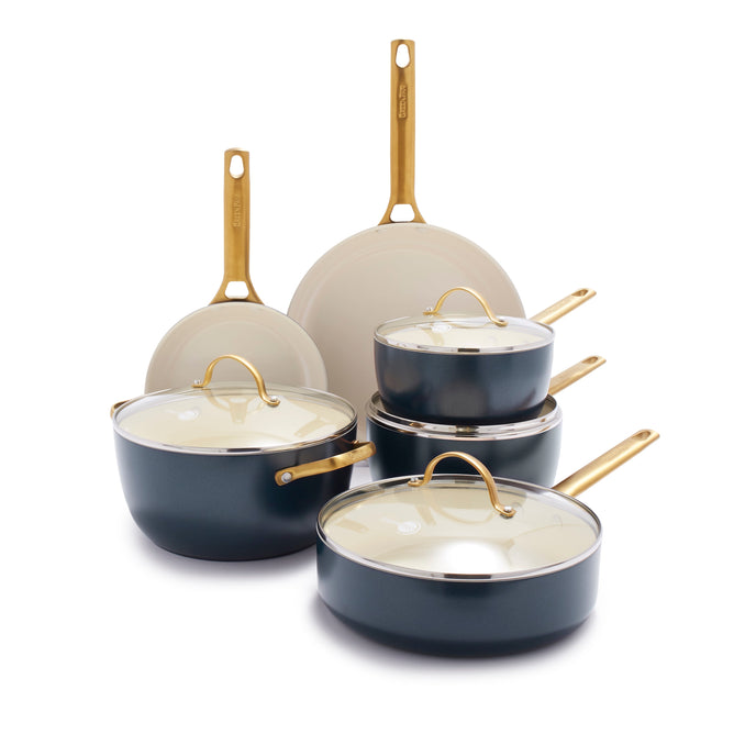 The GreenPan Reserve Ceramic Nonstick 10-Piece Cookware Set features two frying pans and three lidded pots with dark exteriors, light interiors, and golden handles. PFAS-Free with a ceramic nonstick finish, this cookware is showcased elegantly against a plain background.