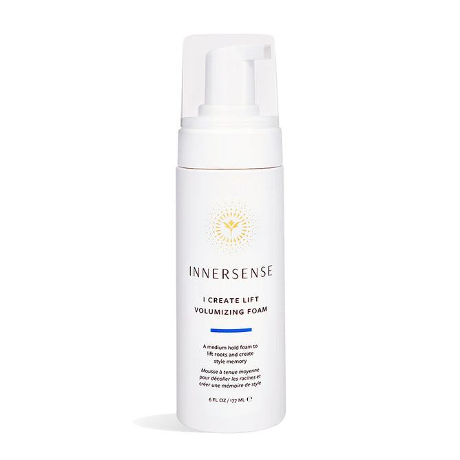 The white bottle of Innersense Organic Beautys I Create Lift Volumizing Foam includes a pump dispenser, features a sunburst label design, and is crafted with organic ingredients to deliver fuller, bouncy locks as a hair styling volumizing foam.
