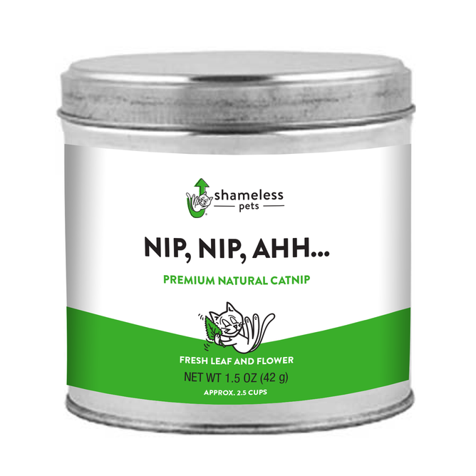 The Nip, Nip, Ahh…Catnip from Shameless Pets is a 1.5 oz (42 g) silver tin featuring premium natural catnip branding with a playful cartoon kitty and green-white palette, holding about 2.5 cups of fresh leaves and flowers for your pets relaxation.