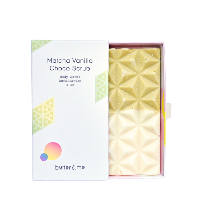 The white box of butter & me elegantly displays pastel geometric designs and text saying Choco Body Scrub Exfoliation 3 oz. Inside, youll find a green and cream Matcha Vanilla bar with a subtle chocolate aroma.