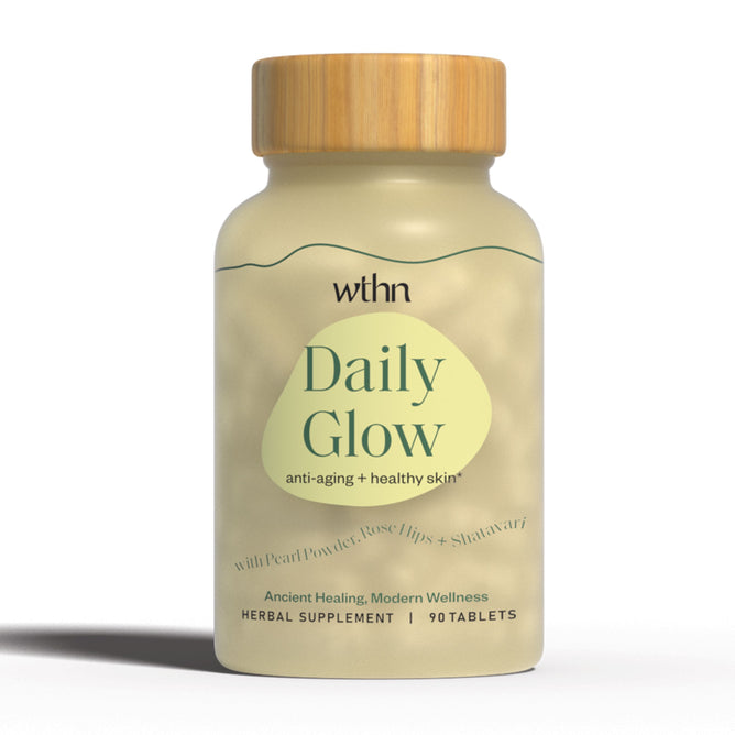 The WTHN Daily Glow supplement boasts anti-aging benefits, supporting healthy skin with antioxidants. It includes 90 tablets of organic pearl powder, rose hips, and shatavari. The beige bottle features a light wood-colored cap for an elegant touch.