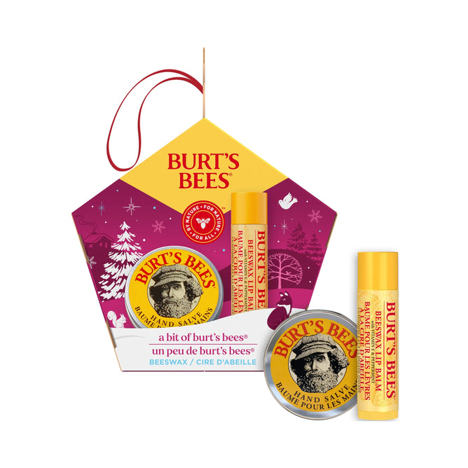 Burts Bees Bit of Burts Gift set includes a hand salve with botanical oils and a beeswax lip balm, all in a hexagonal box featuring a festive winter design and topped with a red string handle for easy gifting.