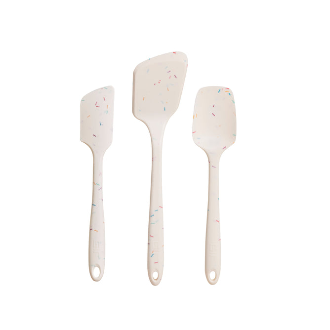 Three white silicone spatulas with confetti specks, made from heat-resistant, pharmaceutical-grade silicone, are shown vertically against a white background. Each differs in size and shape and is part of the GIR 3-Piece Ultimate Tool Set for your kitchen needs.