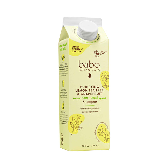 Babo Botanicals Purifying Shampoo for Flat, Oily Hair comes in a leafy, citrus-themed carton labeled Purifying Lemon Tea Tree & Grapefruit, featuring a plant-based formula perfect for oily or flaky scalps. The water-resistant packaging promotes sustainable haircare.