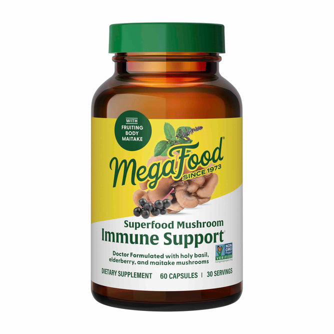 The brown bottle labeled Superfood Mushroom - Immune Support by MegaFood contains 60 capsules. The label, featuring herbs, berries, and mushrooms images, highlights its doctor-formulated blend with holy basil and maitake mushrooms for immune enhancement.