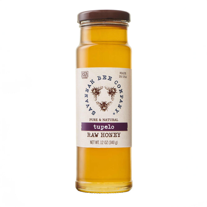 Savannah Bee Companys Tupelo Honey, in an artfully designed 12 oz glass jar with bee graphics, boasts a buttery flavor and pure, natural amber color, reflecting expert beekeeping craftsmanship.