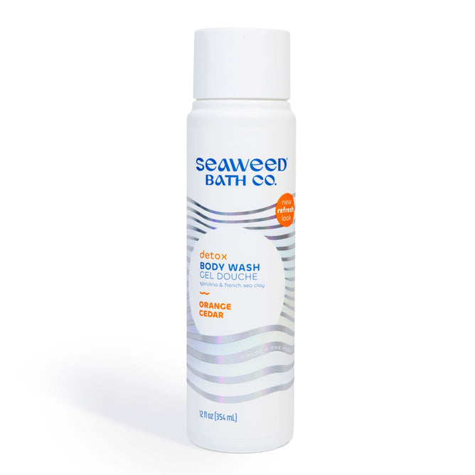 A 12 fl oz (354 ml) bottle of The Seaweed Bath Co. Detox Purifying Body Wash in Orange Cedar boasts blue text and a wave design on a white bottle, featuring an orange label New refined look. Infused with Bladderwrack Seaweed for a refreshing cleanse.