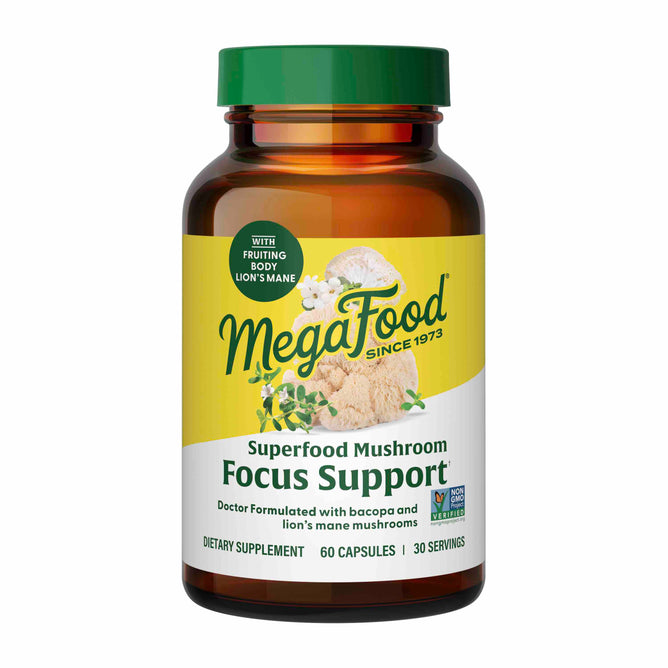 A brown bottle of MegaFoods Superfood Mushroom - Focus Support features Lions Mane mushrooms and Bacopa monnieri. The label highlights non-GMO, 60 capsules, and 30 servings. Its design showcases white mushrooms and green leaves, emphasizing its status as a premier focus supplement.